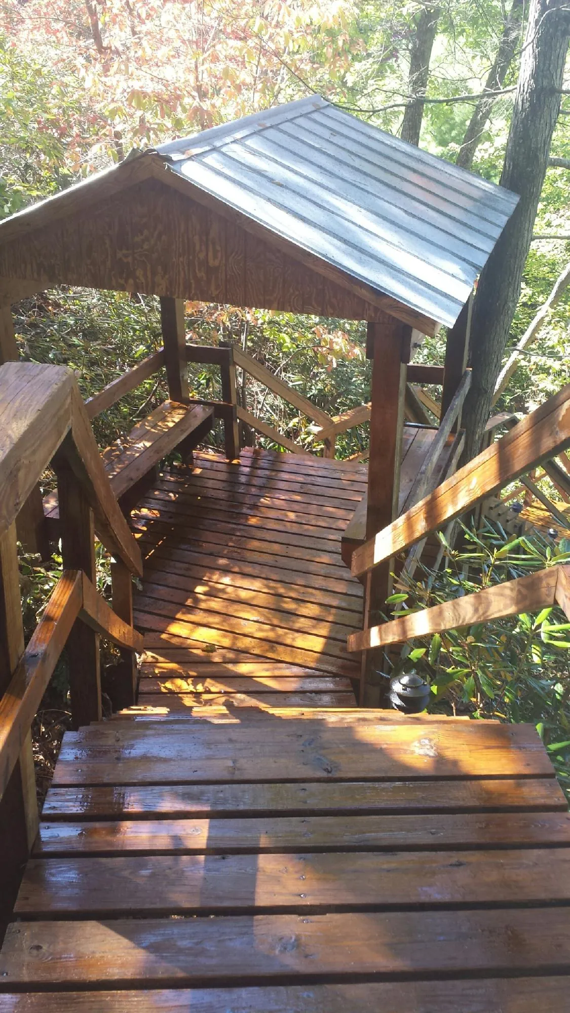 Freshly stained wood walkway and covered shelter with a metal roof in Covington